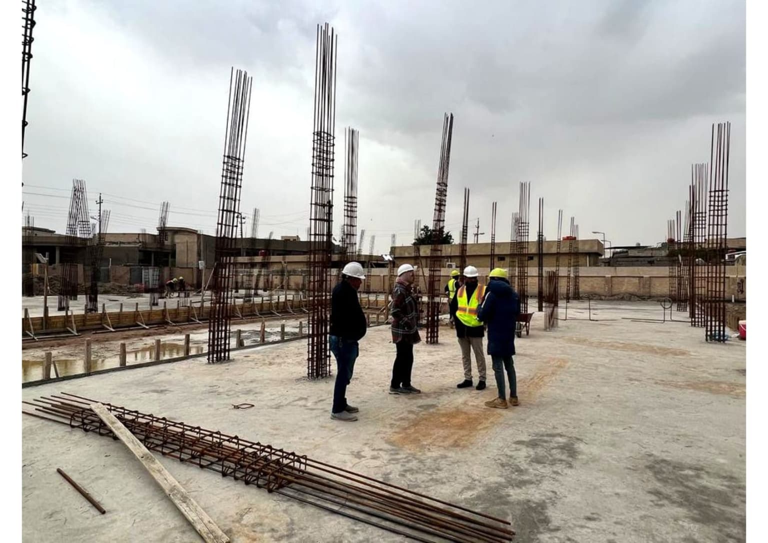 Column reinforcement cages rising from a cast floor slab